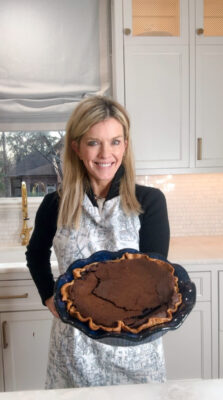 Jamie Tarence of Family Savvy hold a Chocolate Chess Pie in her kitchen