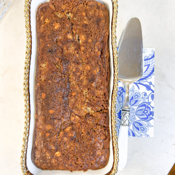 Photo of Family Savvy's Banana Nut Bread in a white and gold loaf pan