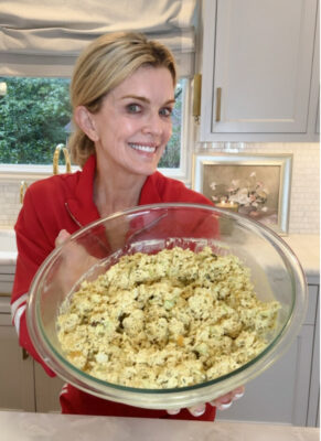 Jamie Tarence of Family Savvy holding a glass bowl of her Curry Chicken Salad recipe