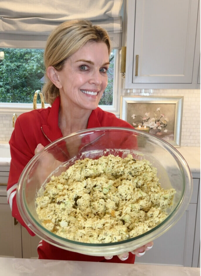 Jamie Tarence of Family Savvy holding a glass bowl of her Curry Chicken Salad recipe