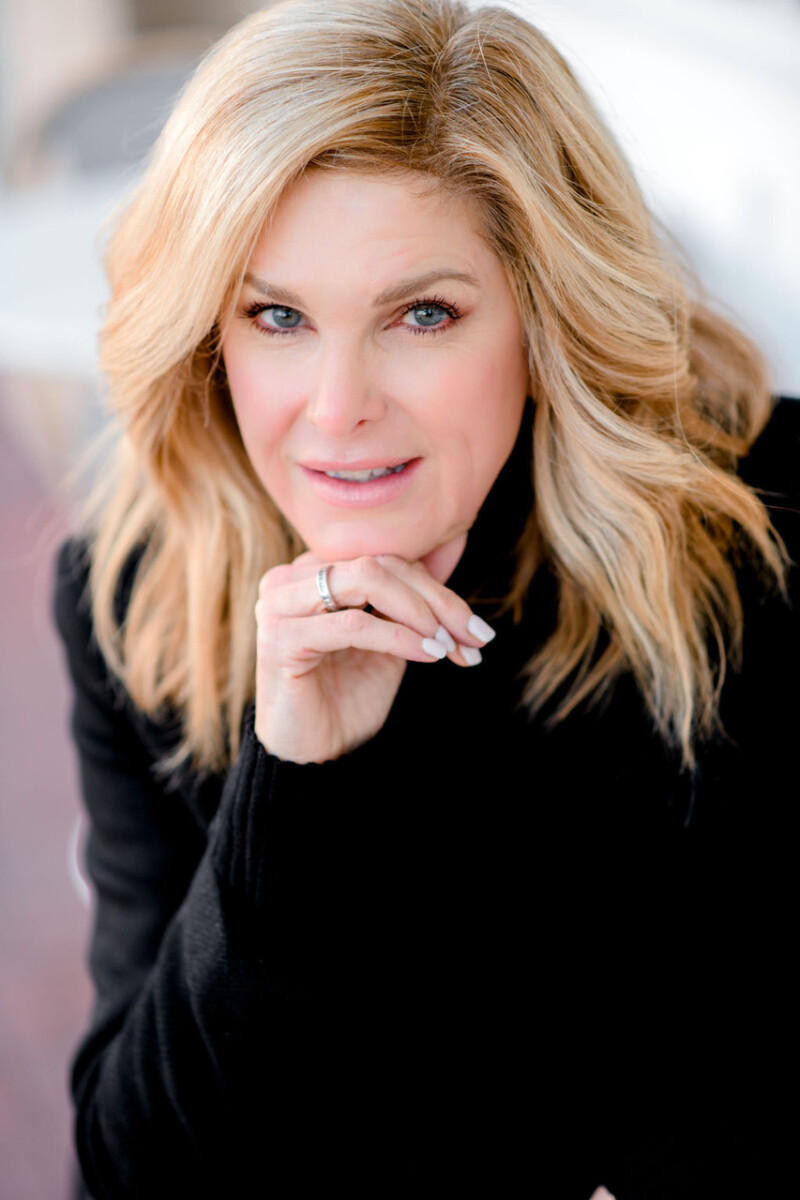 Headshot of Tanya Foster, a midlife fashion blogger and influencer, wearing a black sweater