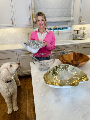 Jamie Tarence, founder of Family Savvy, holding her Beatriz Ball and Nambe salad bowls
