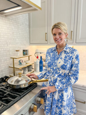 Jamie Tarence of Family Savvy standing in her kitchen with an Our Place pan