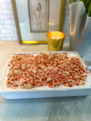 4-ingredient frozen strawberry cheesecake dessert in a white baking dish sitting on a marble kitchen counter