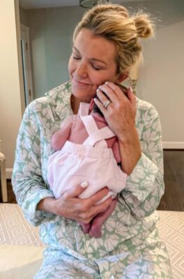 Jamie Tarence of Family Savvy holding her newborn grandbaby Anne Parker
