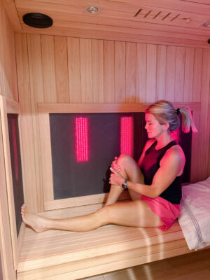 Jamie Tarence of Family Savvy stretching in her Sunlighten infrared sauna