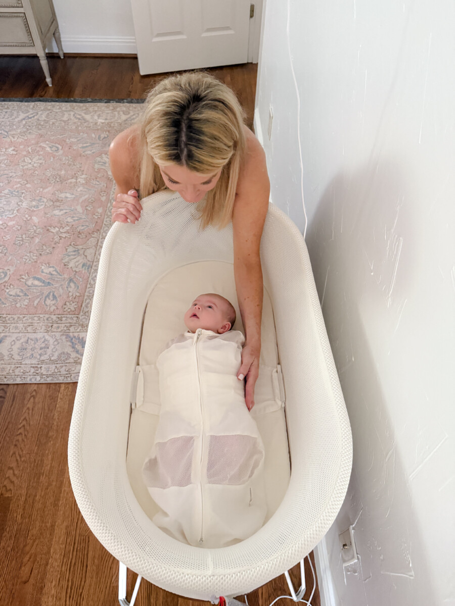 Jamie Tarence of Family Savvy looking down at her baby granddaughter Mary Owen in the SNOO Smart Sleeper