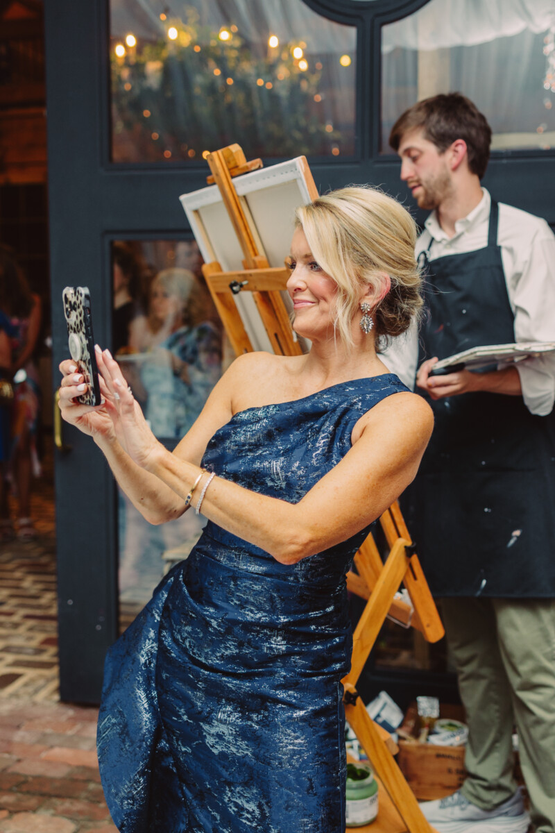 Jamie Tarence of Family Savvy using her phone while wearing a long blue dress