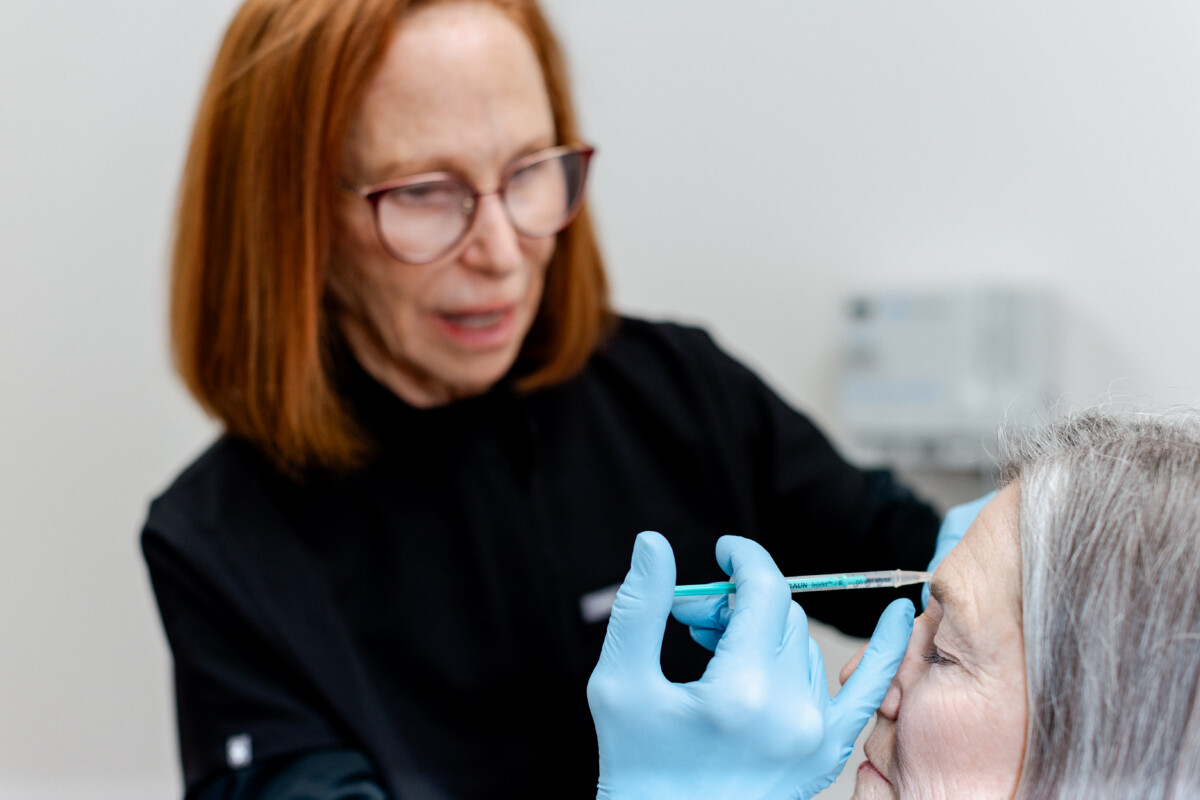 Dermatologist and experienced injector, Dr. Jo Lynne Herzog injecting a patient's forehead
