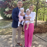 Jamie and Zane Tarence holding their grandbabies, Anne Parker and Mary Owen