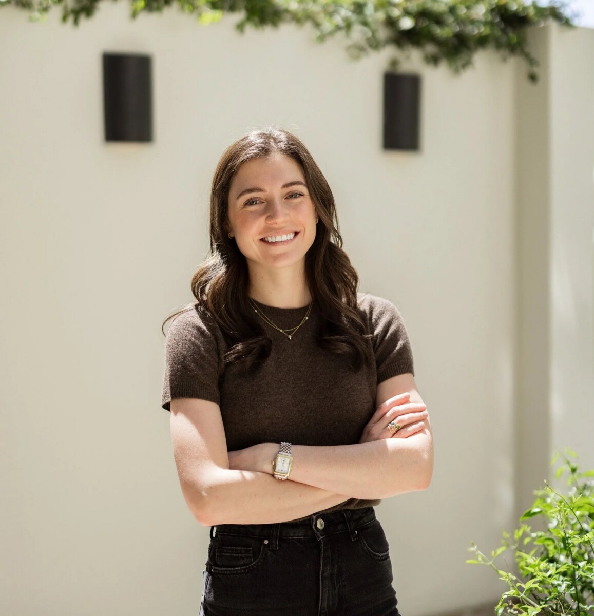Interior designer Ellie Stein standing outdoors in a brown outfit.